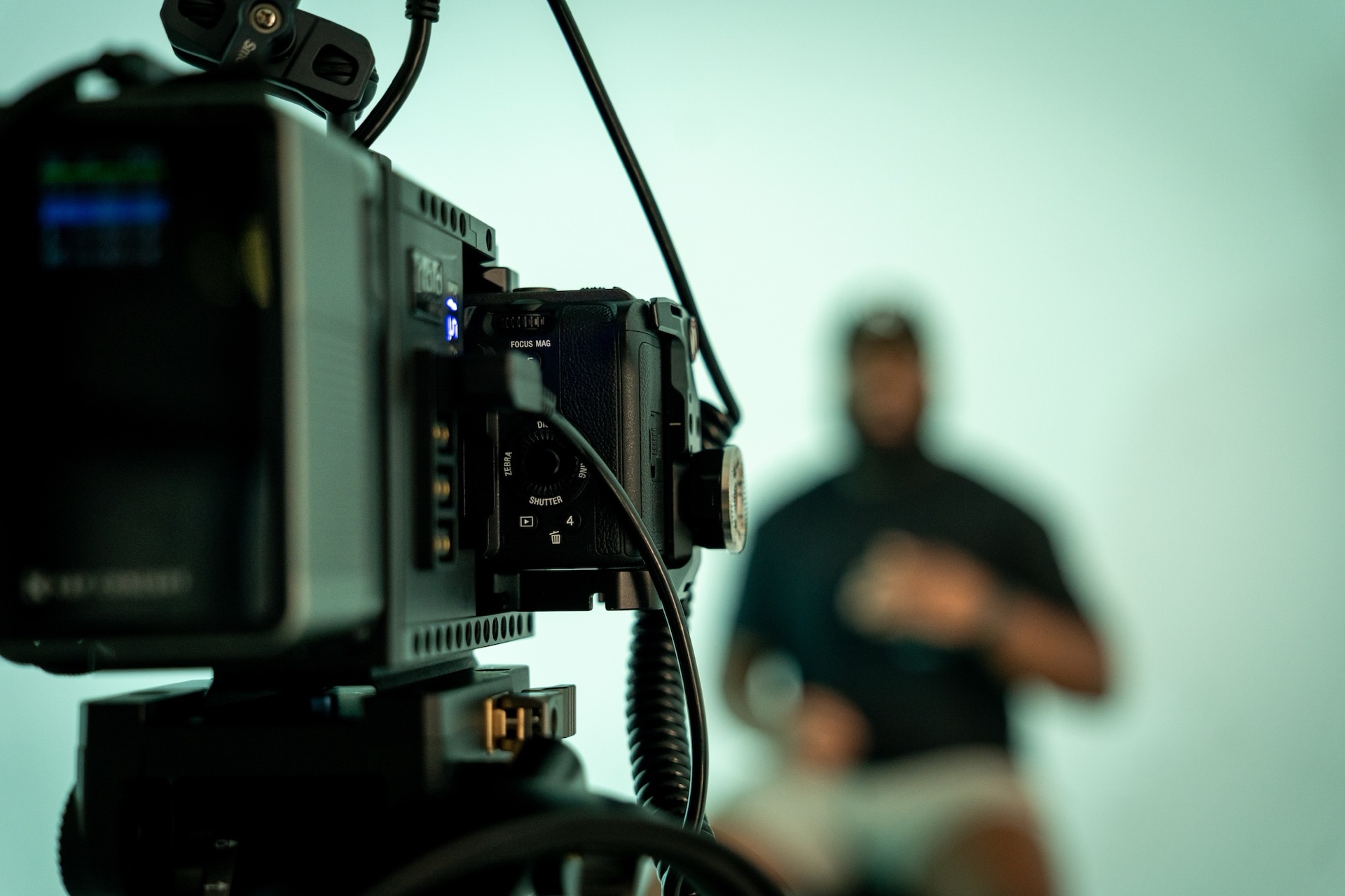 A cinema camera on set, framing an interview subject